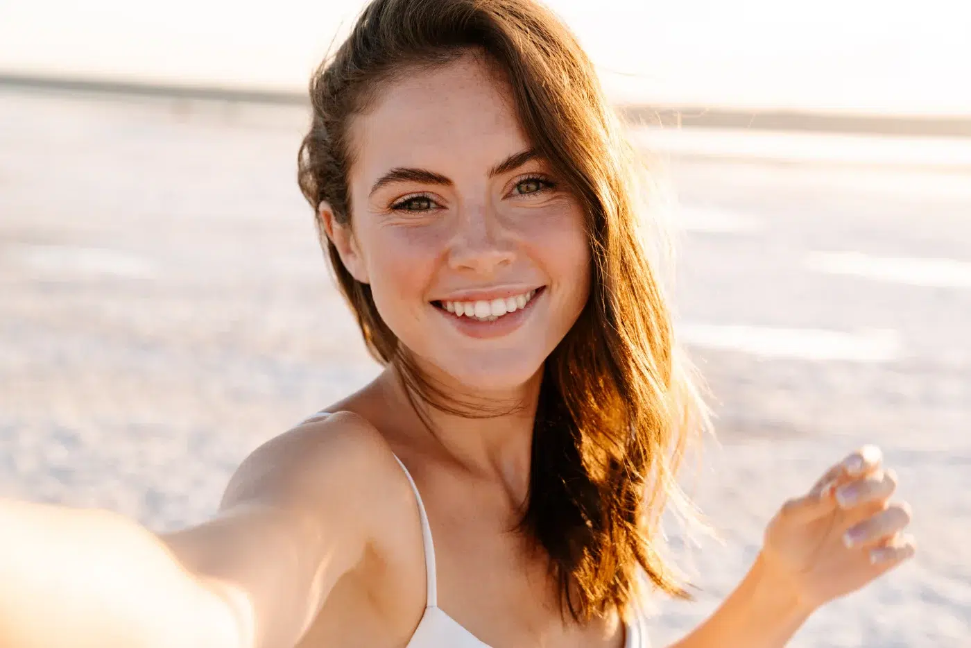 Cheery young pretty girl walking outdoors skinvive