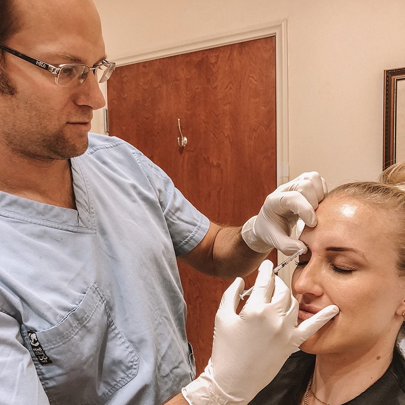 Female patient getting injected with neuromodulator