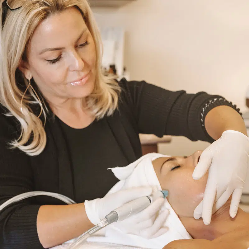 Female patient receiving face treatments